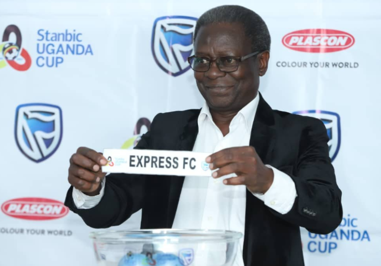 Moses Matovu holds an Express FC slip at a Stanbic Uganda Cup draw.
