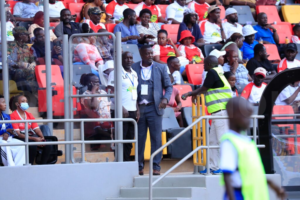 Andy Lule receiving instructions from Wasswa Bbosa in the stands during Kitara FC’s CAF Confederation Cup first leg against Mogadishu City.