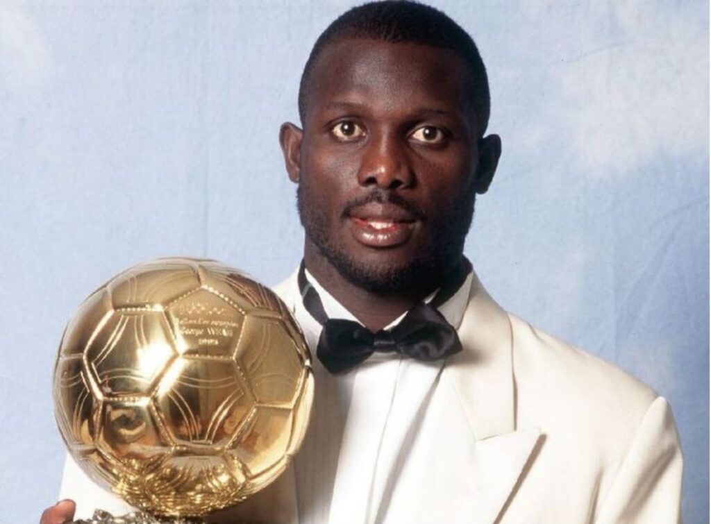 George Weah holding the 1995 Ballon d'Or after becoming the first African winner