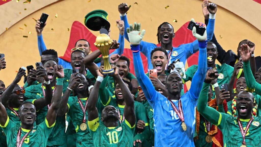 Senegal players celebrate with the AFCON 2025 trophy and gold medals following their victory over Morocco in the Africa Cup of Nations final.