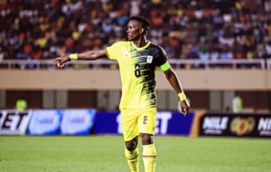 Khalid Aucho wearing Uganda Cranes’ yellow number 8 jersey and captain’s armband, pointing during a match