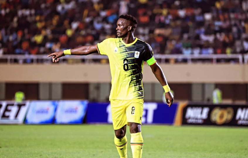 Khalid Aucho wearing Uganda Cranes’ yellow number 8 jersey and captain’s armband, pointing during a match