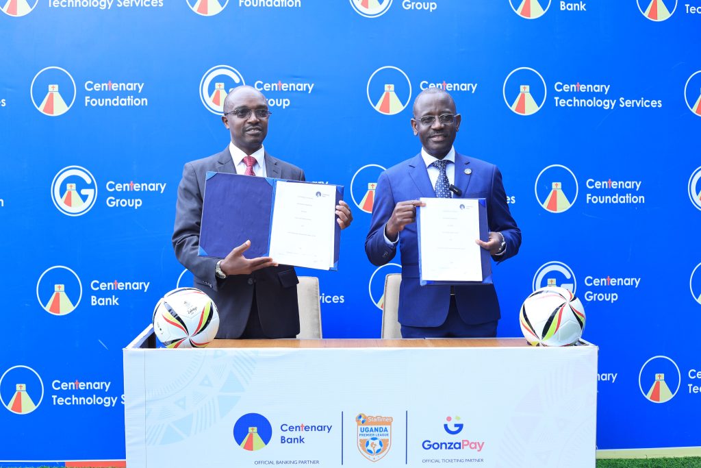 UPL board chairman Arinaitwe Rugyendo and Centenary Bank managing director Godfrey Byekwaso at the Shs204m partnership signing in Kampala.
