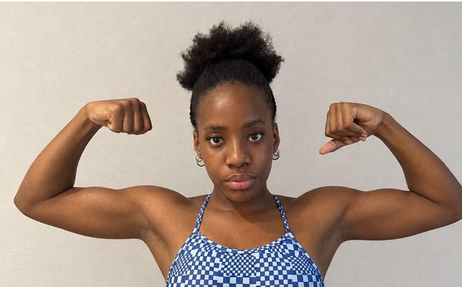 Mary Peyton Suubi, Uganda's national swimming record holder, flexes her arms ahead of the Dakar 2026 Youth Olympic Games in Senegal.