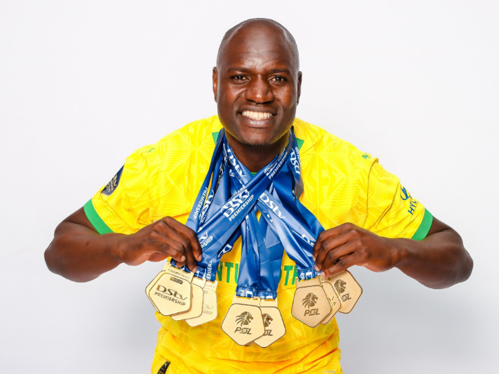 Denis Onyango wearing 10 Premier Soccer League winners’ medals around his neck.