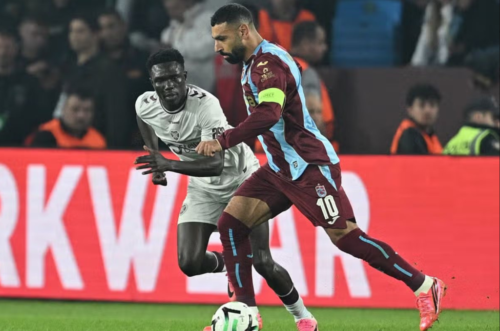 Uganda Cranes forward Rogers Mato of Hearts challenges Trabzonspor captain during a European match after being deployed at left-back.