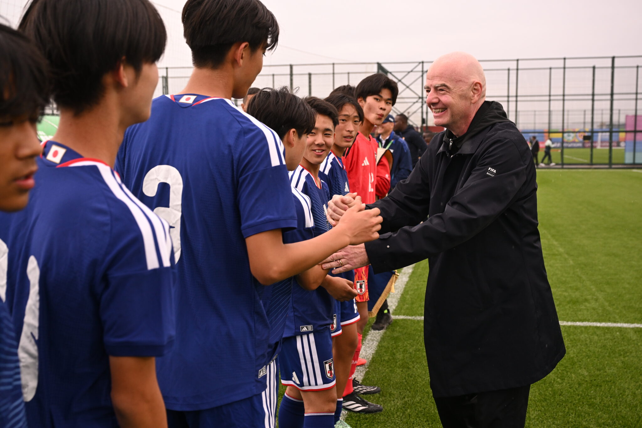 Gianni Infantino shakes hands with Japan’s young footballers at the FIFA U-15 World Cup & Festival in Baku.